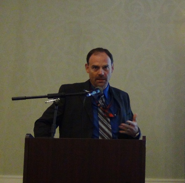 Dr. Al Emondi, lead scientist, Space and Naval Warfare Systems Center Atlantic, addresses the chapter in August on the structure of science and technology in his current position.